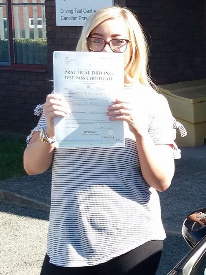 An SMS Driving School pupil celebrating passing their driving test at Rhyl test centre