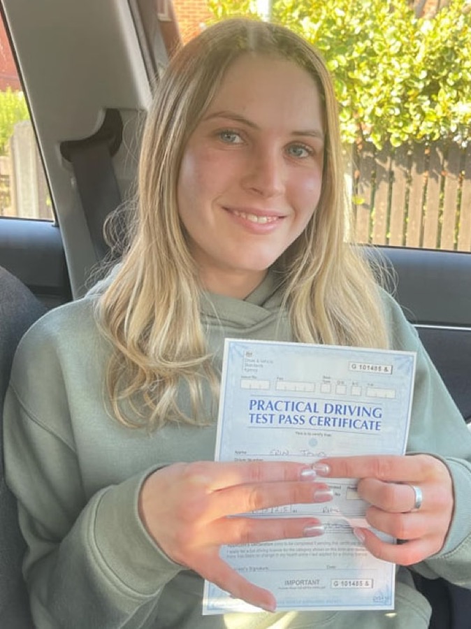 An SMS Driving School pupil celebrating passing their driving test at Rhyl test centre
