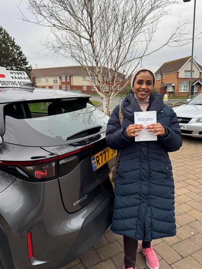 An SMS Driving School pupil celebrating passing their driving test at Rhyl test centre