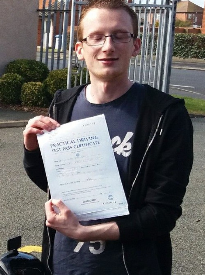 An SMS Driving School pupil celebrating passing their driving test at Rhyl test centre