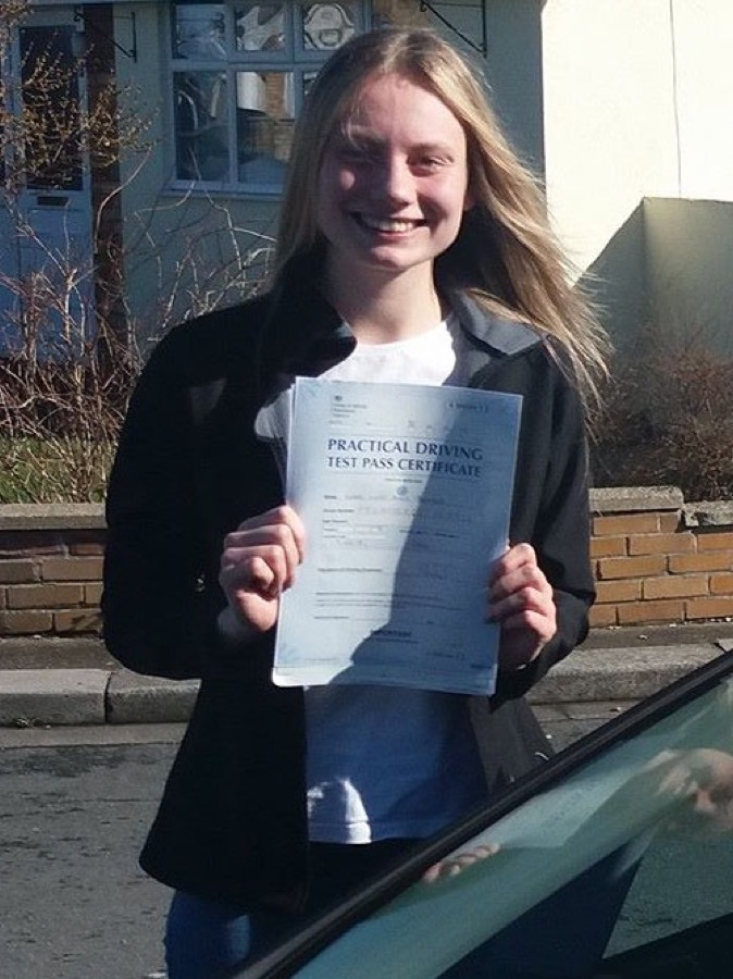 An SMS Driving School pupil celebrating passing their driving test at Rhyl test centre