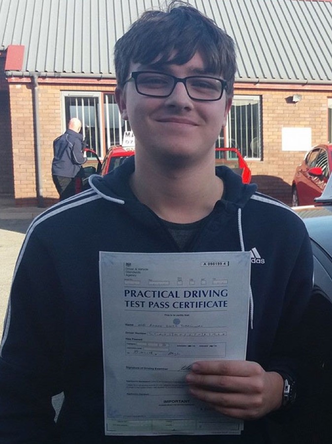 An SMS Driving School pupil celebrating passing their driving test at Rhyl test centre