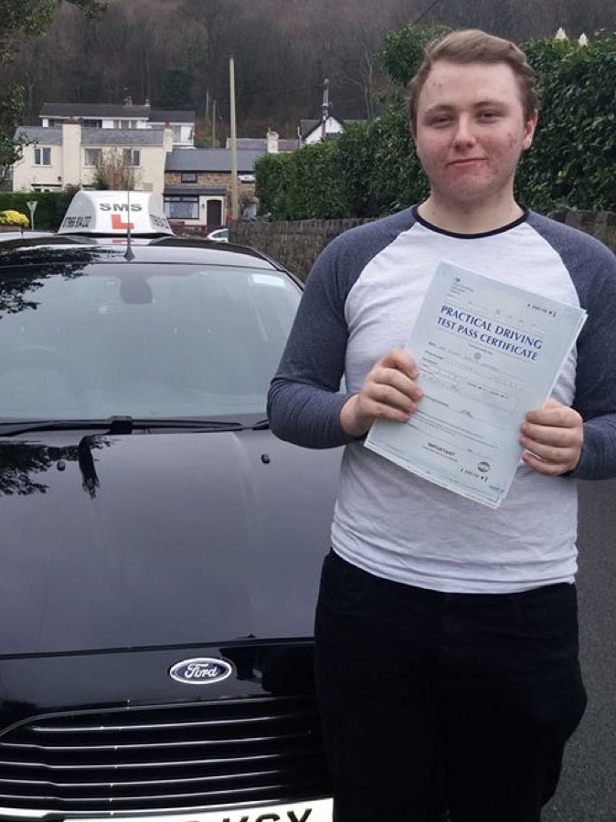 An SMS Driving School pupil celebrating passing their driving test at Rhyl test centre