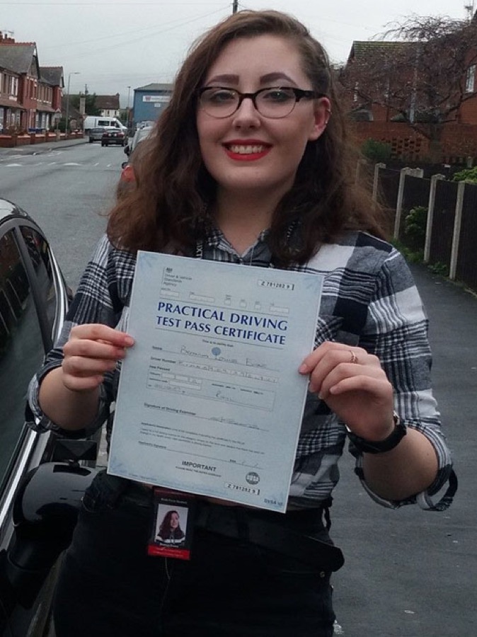 An SMS Driving School pupil celebrating passing their driving test at Rhyl test centre