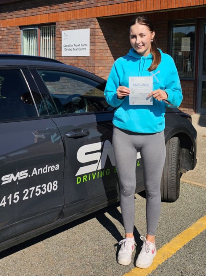 An SMS Driving School pupil celebrating passing their driving test at Rhyl test centre